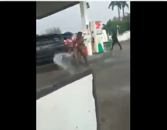ICYMI: Watch Viral Video Of Moment Woman Goes Naked At Filling Station, Sprays Fuel